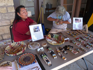 Local Native Americans explaining the process of making Hopi baskets and dolls