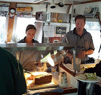 Staff serving up a delicious meal.