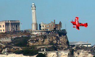 Oracle stunt plane with the Rock in the background during San Francisco Fleetweek