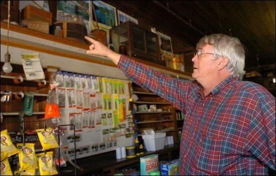Chip Gibbes, owner of the Learned Country Store, pointing out old memorabilia.