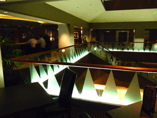 The lounge area has stylish decor with stars overhead that change colors