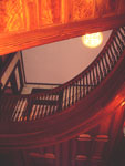 The large staircase at Grace Manor. Note the rich wood grain and detailed workmanship