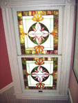 The house includes several charming stain glass windows, which dramatically show light through in the late afternoons