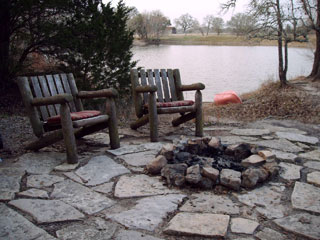 View of the firepit next to the fishing pond