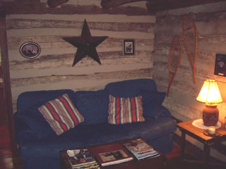 The living room of the Lonesome Dove B&B with Texas star, snow shoes, and photos of the owner's ancestors lining the walls
