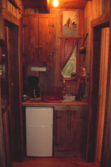 The area in back of teh cabin includes a kitchenette and bathroom
