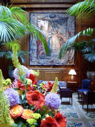 A large display of fresh flowers are a centerpiece, with rare Belgian tapestries along the walls, which date to the 16th century at the Adolphus Hotel