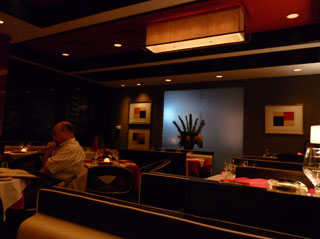 The dining area of the Valentino is appealing and romantic with rich red designs